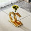 Table de salle à manger rectangulaire en verre avec base dorée en forme de CO