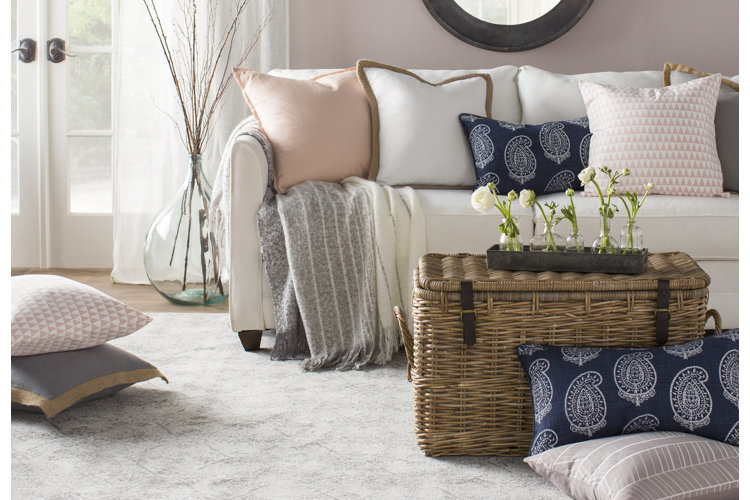 white linen sofa with decorative throw pillows