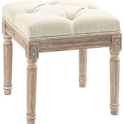 Tabouret vintage rembourré beige respirant avec siège et pieds en bois rustiques, idéal pour le salon ou la chambre. Confort et confort garantis.
