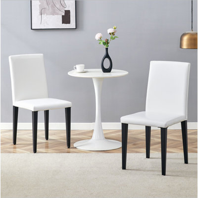 Ensemble de 2 chaises de salle à manger en polyuréthane - siège en éponge, pieds en métal noir - dossier ergonomique (chaises seulement)