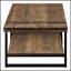 Table basse rectangulaire en stratifié brun avec structure en métal noir, parfaite pour le salon et le rangement