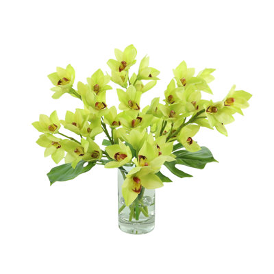 Orchids And Leaves In A Glass Vase