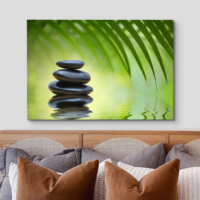«Green Bamboo Leaves over Zen Stones Pyramid Reflecting in Water Surface», reproduction de photo sur toile tendue