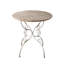 Table ronde en bois avec pieds à volutes en métal