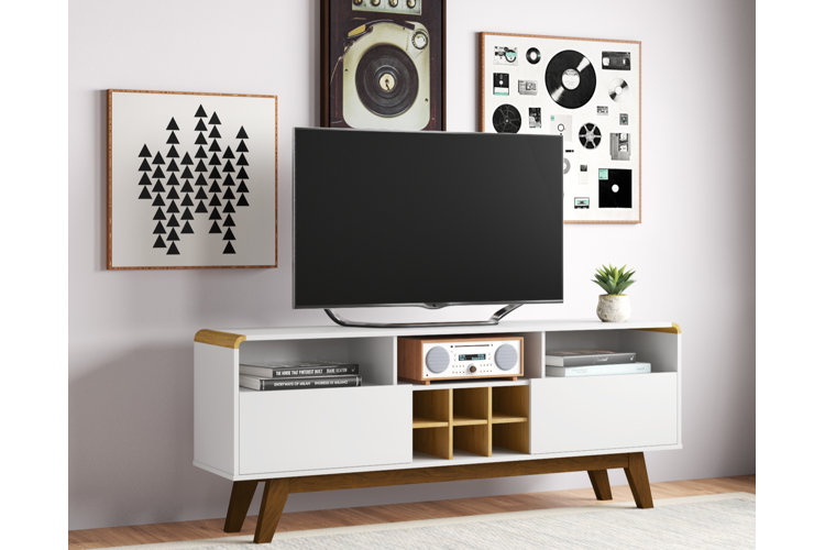 Large print artwork on a wall behind TV on a white mid-century modern TV stand