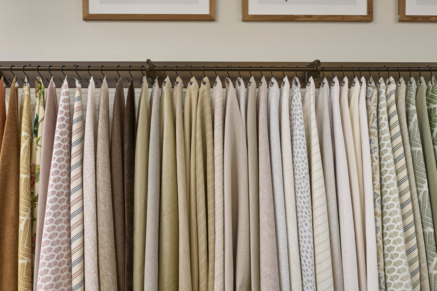 Fabric samples hanging on a rack.