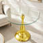 Table d'appoint en verre trempé avec base en métal or rose et design épuré-1026117237