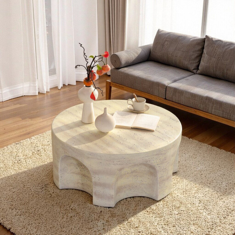 Table basse ronde avec base arquée