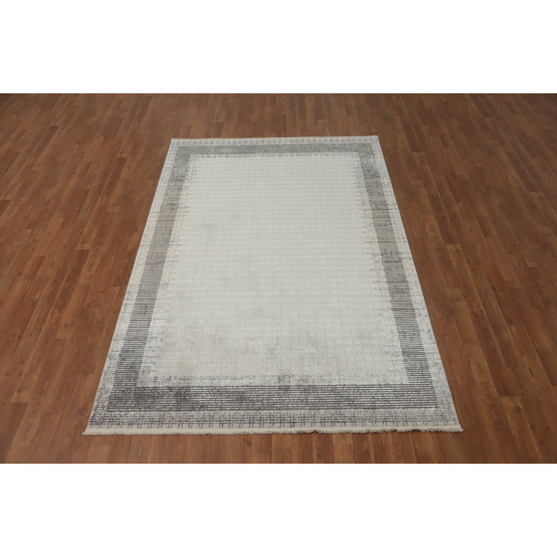 Tapis élégant aux tons neutres 5 x 8 avec motif de bordure subtile