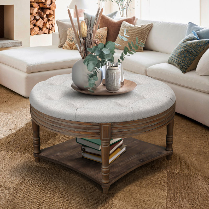 Large round ottoman coffee table in light grey, 2-tier design with button tufted top & wood storage shelf